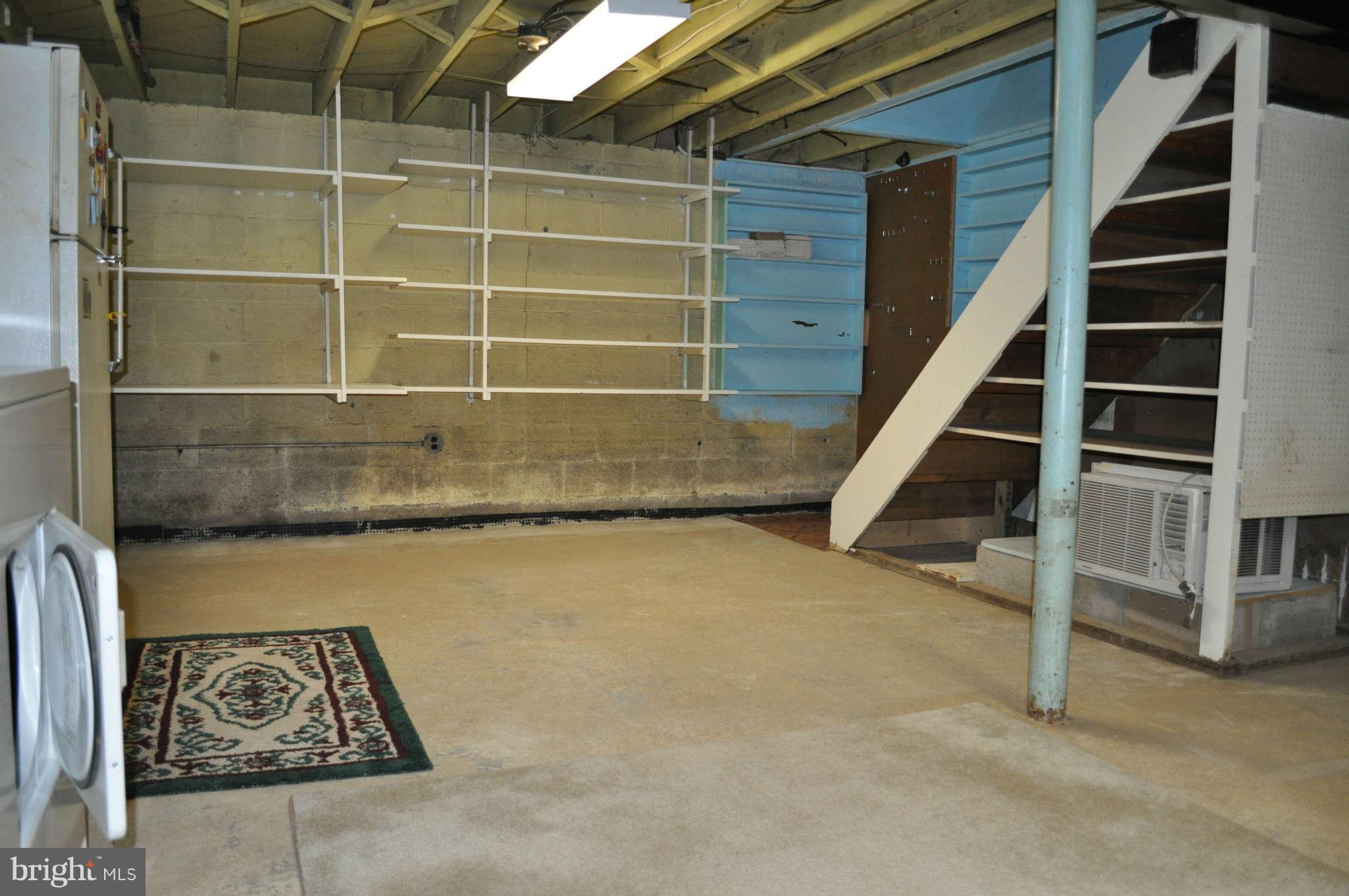 1021 Kingston Road Baltimore, MD 21208 - Photo 17 of 20 a view of an empty room with stairs and wooden floor