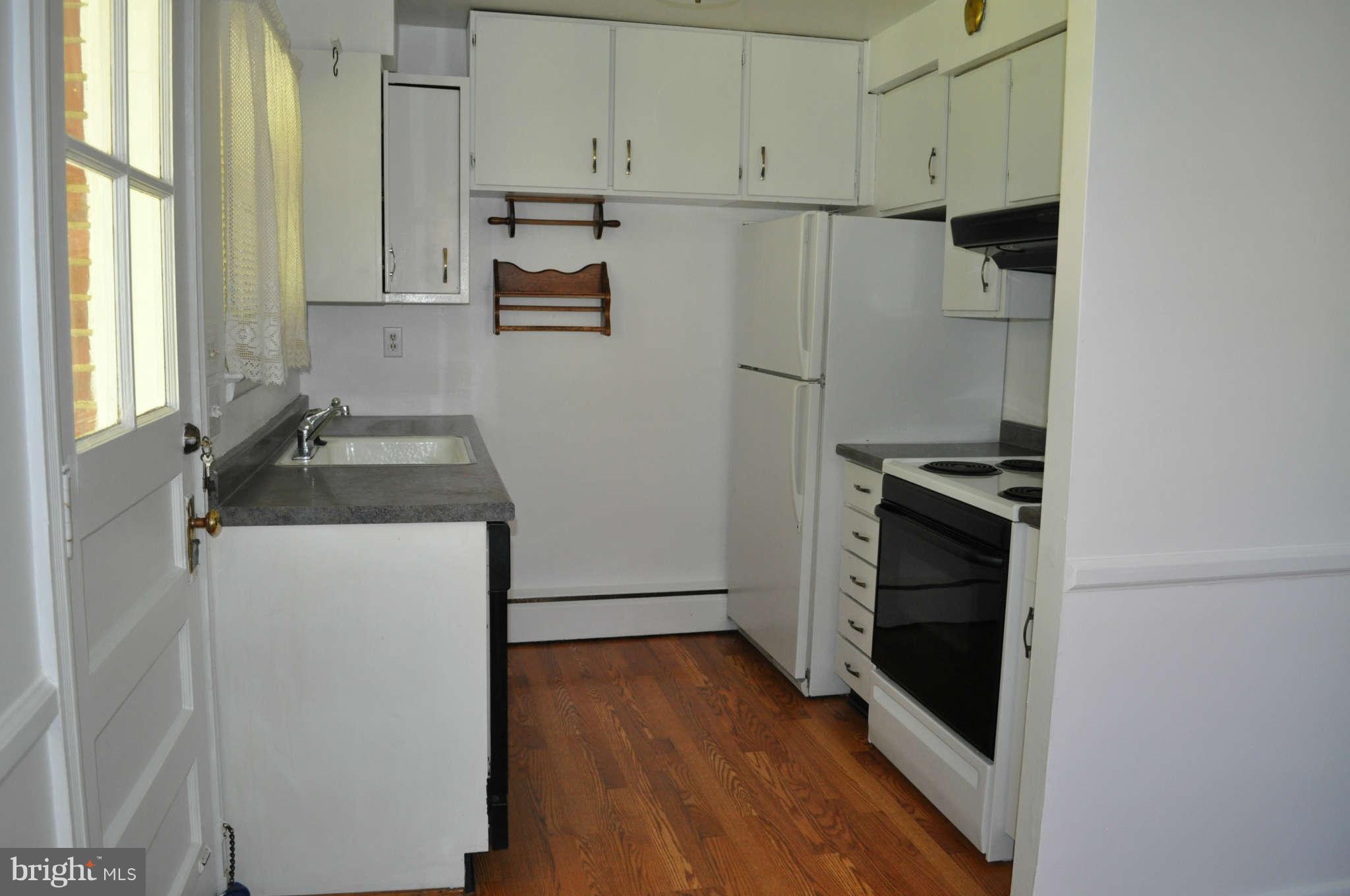 1021 Kingston Road Baltimore, MD 21208 - Photo 8 of 20 a kitchen with a refrigerator and a stove