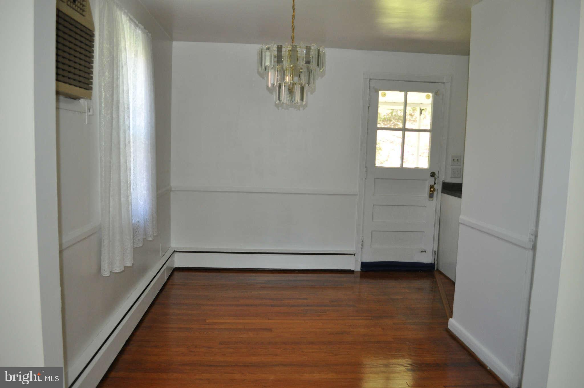 1021 Kingston Road Baltimore, MD 21208 - Photo 9 of 20 a view of empty room with wooden floor and fan