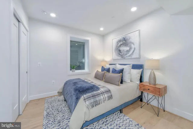 a bedroom with bed and night stand