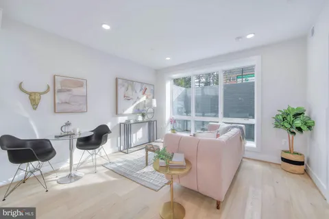 a living room with furniture and a painting