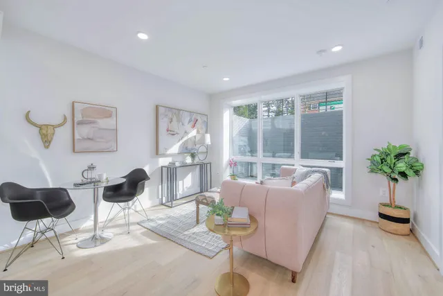 a living room with furniture and a painting