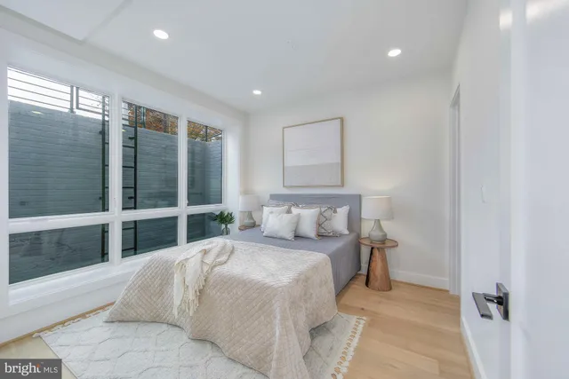 a bedroom with a bed and glass walk in closet
