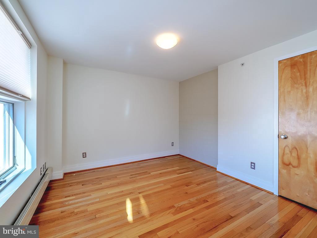 1530 14th Street Northwest, Unit 3B Washington, DC 20005 - Photo 13 of 28 a view of empty room with wooden floor and fan
