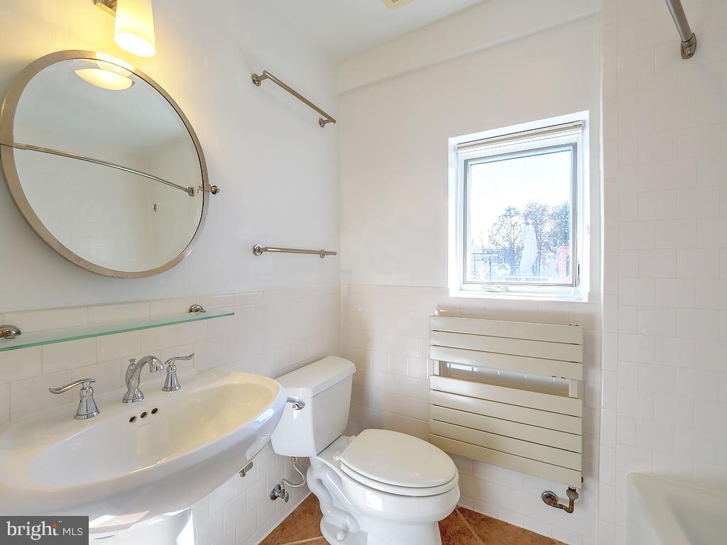 1530 14th Street Northwest, Unit 3B Washington, DC 20005 - Photo 17 of 28 a bathroom with a sink a toilet and a mirror