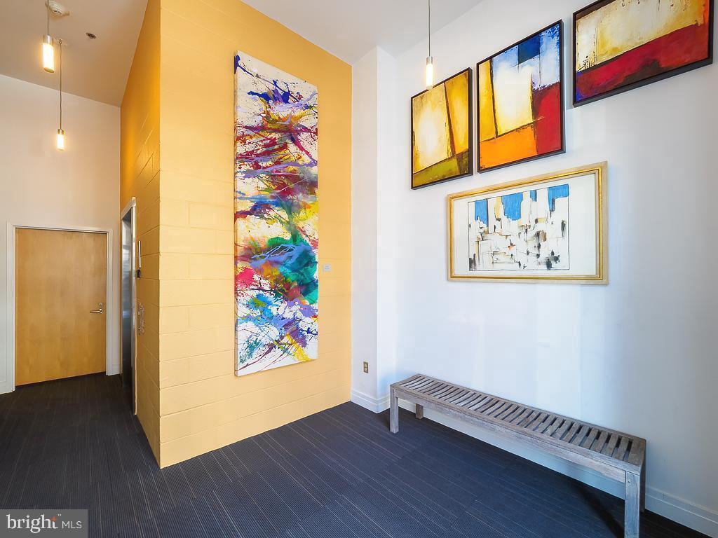 1530 14th Street Northwest, Unit 3B Washington, DC 20005 - Photo 20 of 28 a view of a hallway with wooden floor and a painting on the wall