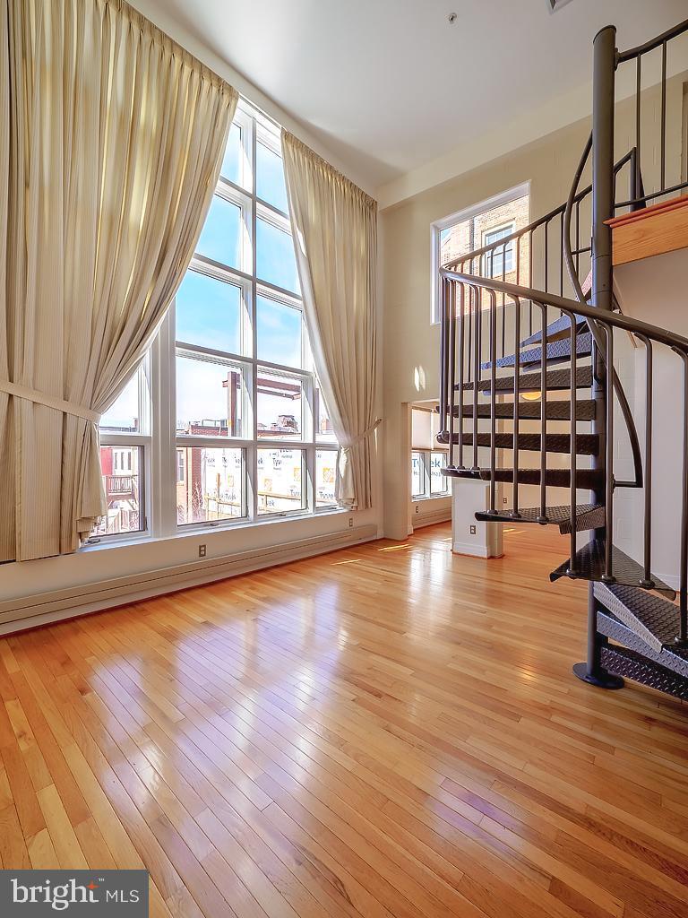 1530 14th Street Northwest, Unit 3B Washington, DC 20005 - Photo 3 of 28 a view of an empty room with wooden floor and a window