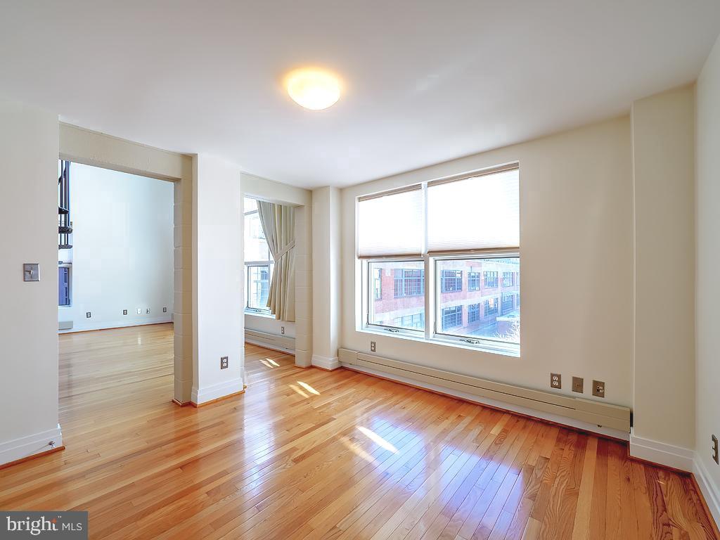 1530 14th Street Northwest, Unit 3B Washington, DC 20005 - Photo 9 of 28 an empty room with wooden floor and windows