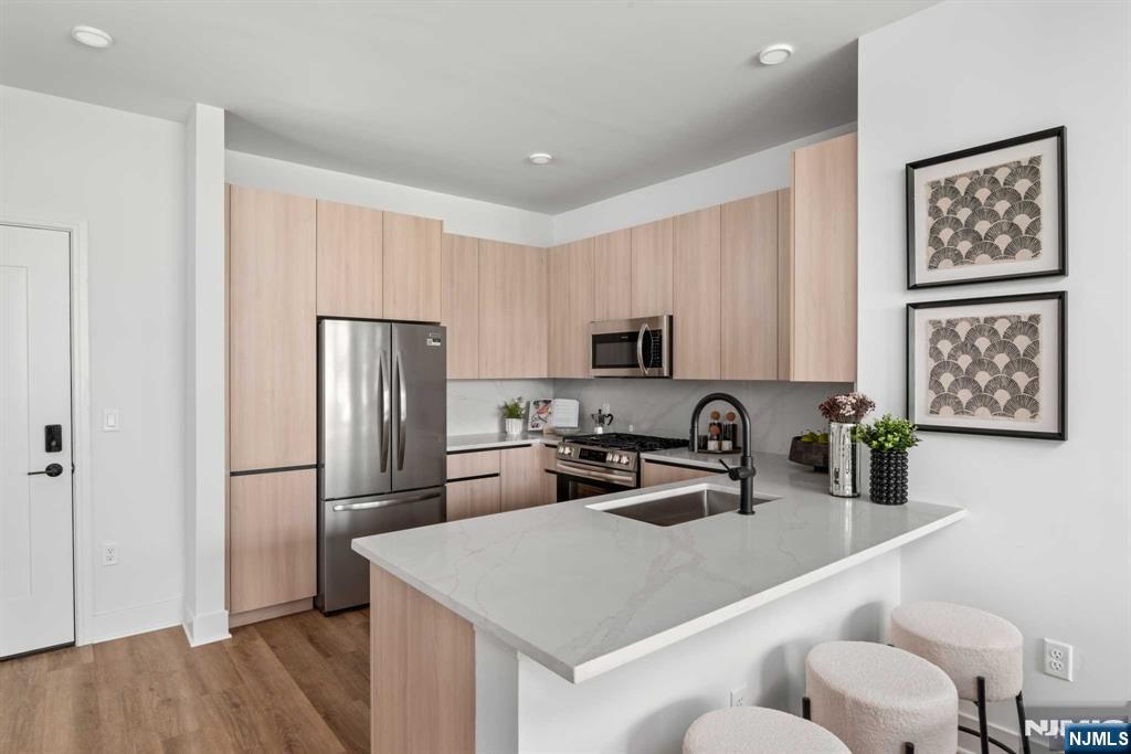18 Park Avenue, Unit 1218 Old Tappan, NJ 07675 - Photo 24 of 33 a kitchen with stainless steel appliances a refrigerator sink and microwave