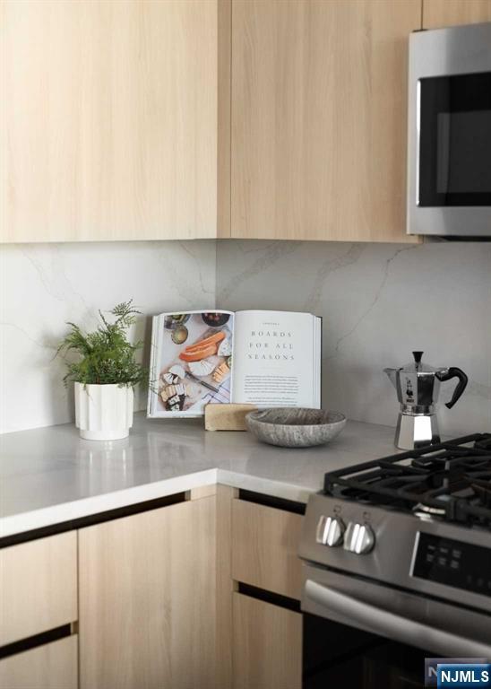 18 Park Avenue, Unit 1218 Old Tappan, NJ 07675 - Photo 25 of 33 a kitchen with stainless steel appliances granite countertop a sink stove and white cabinets