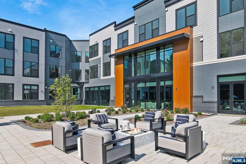 18 Park Avenue, Unit 1218 Old Tappan, NJ 07675 - Photo 31 of 33 a view of a building with couches in the patio