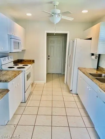 a kitchen with a stove a sink and a refrigerator