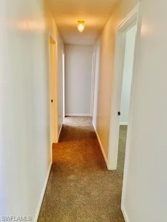 a view of a hallway with white walls
