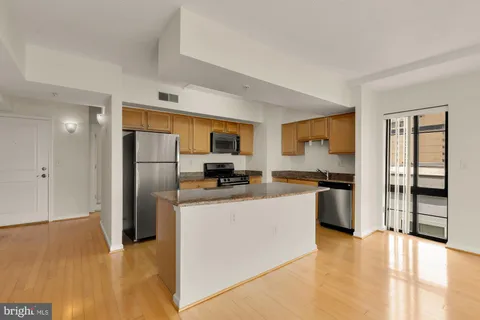 a kitchen with stainless steel appliances a refrigerator and a stove top oven