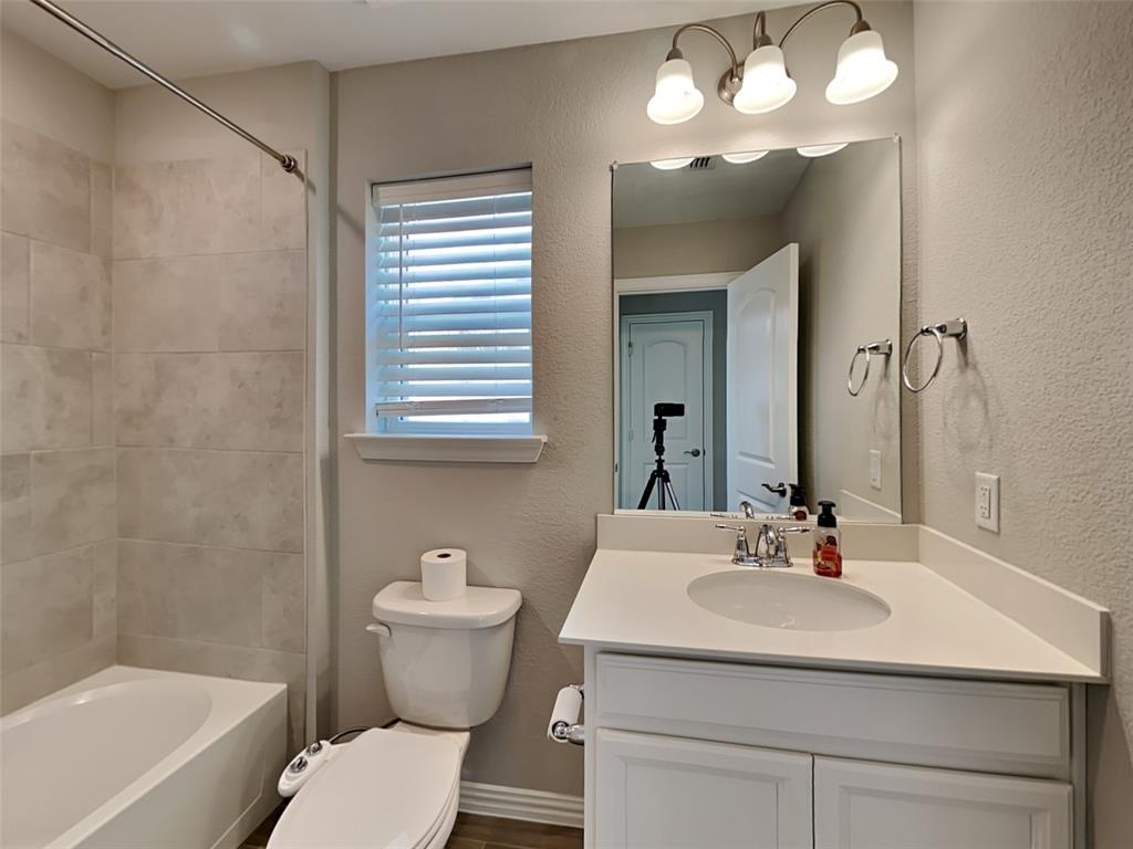 251 Novacek Street Irving, TX 75063 - Photo 15 of 18 a bathroom with a sink and a mirror