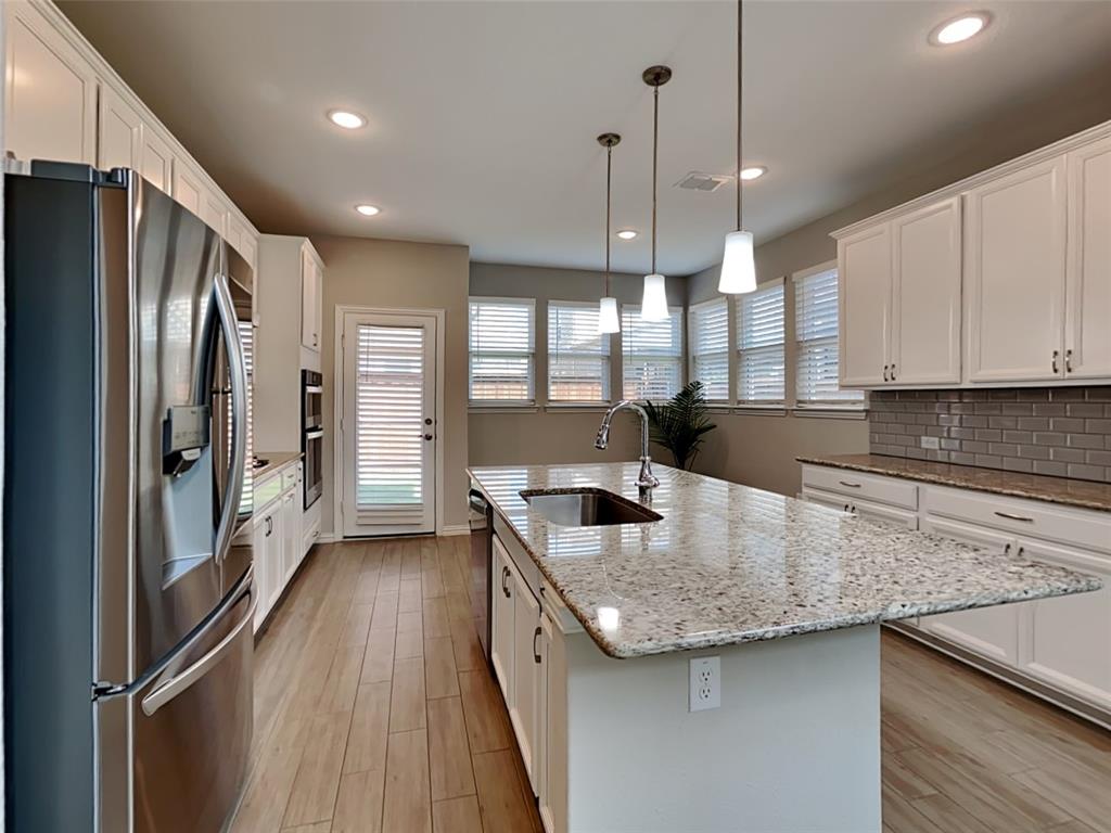 251 Novacek Street Irving, TX 75063 - Photo 5 of 18 a kitchen with stainless steel appliances granite countertop a sink a stove and a refrigerator