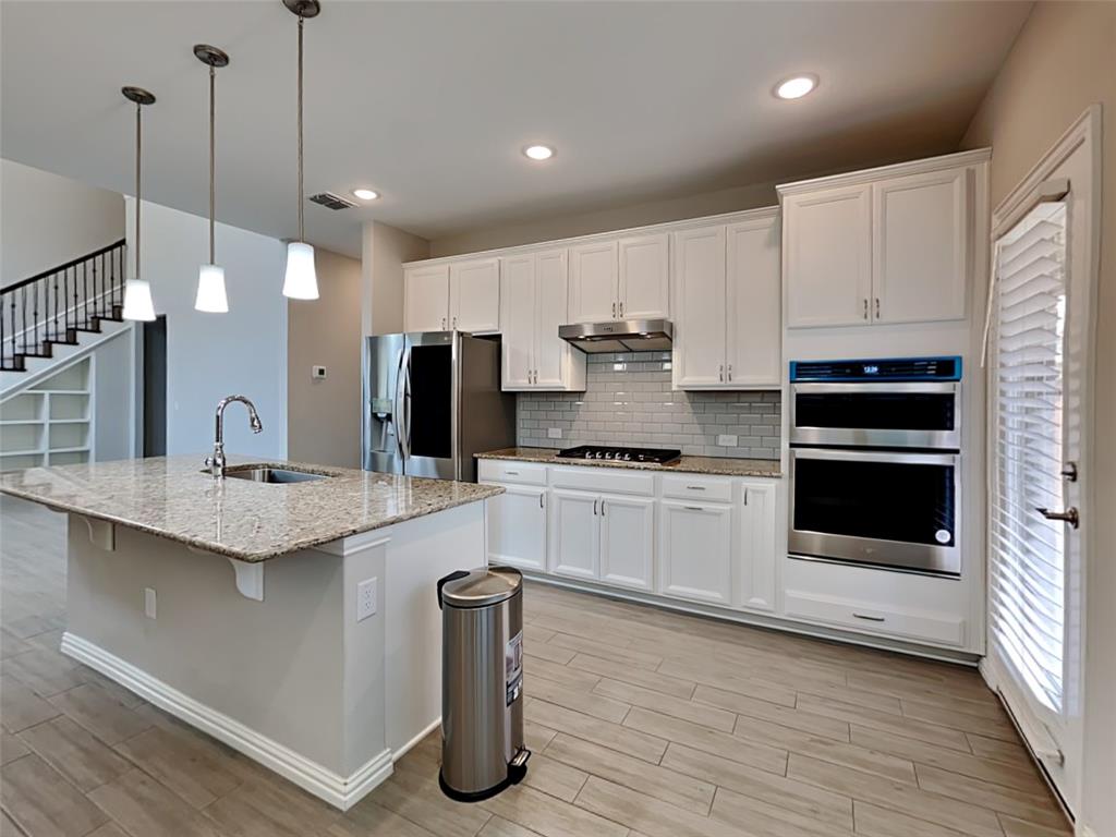 251 Novacek Street Irving, TX 75063 - Photo 6 of 18 a kitchen with stainless steel appliances granite countertop a sink a stove and a refrigerator