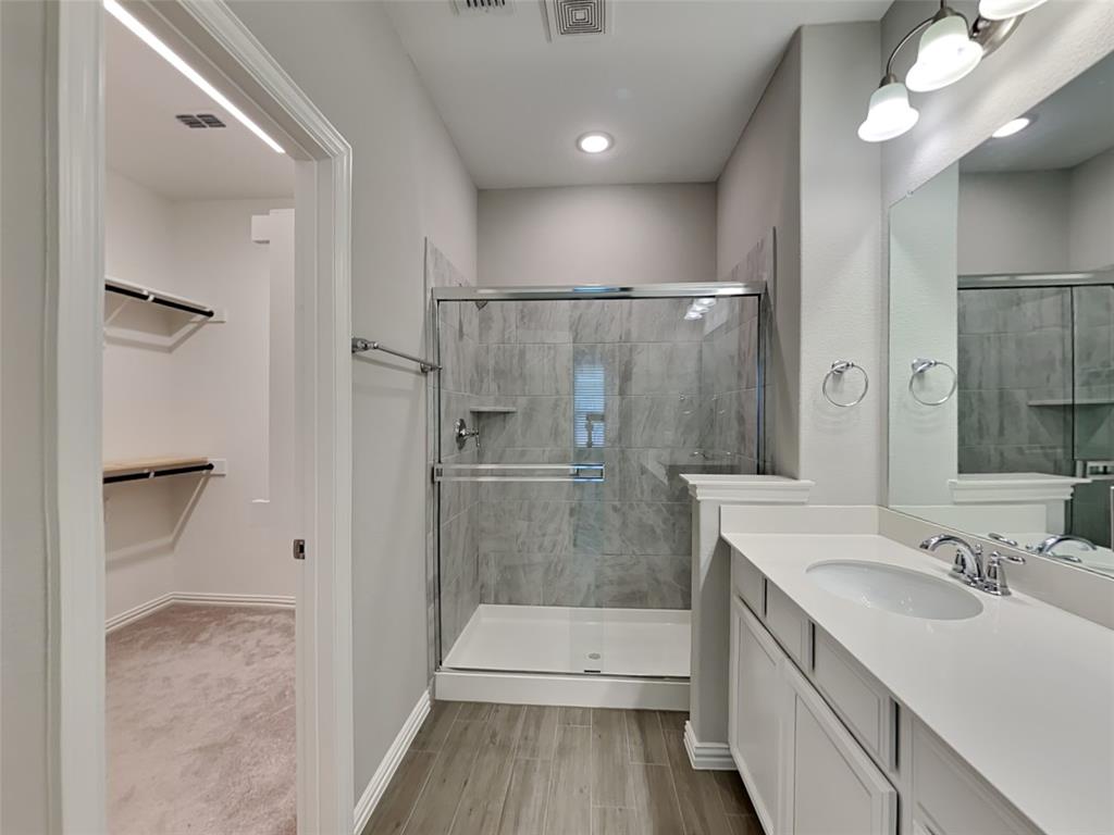 251 Novacek Street Irving, TX 75063 - Photo 10 of 18 a bathroom with a sink a toilet and shower