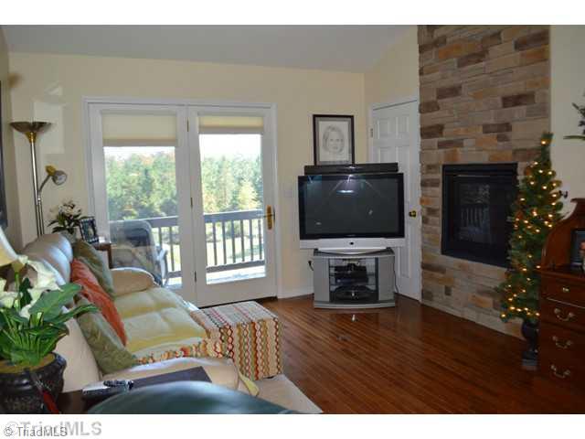 5415 Cook Collier Road Liberty, NC 27298 - Photo 3 of 16 Living Room. Warm Cozy Living Room with Gas Fireplace and French Doors leading out to the balcony