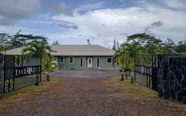 a view of house with a yard and sitting area