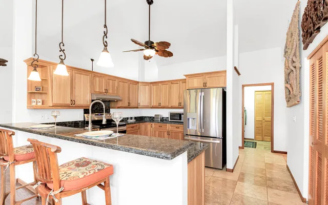a kitchen with stainless steel appliances granite countertop a refrigerator stove microwave and sink