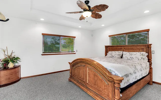 a bathroom with a granite countertop double vanity sink a mirror and a shower