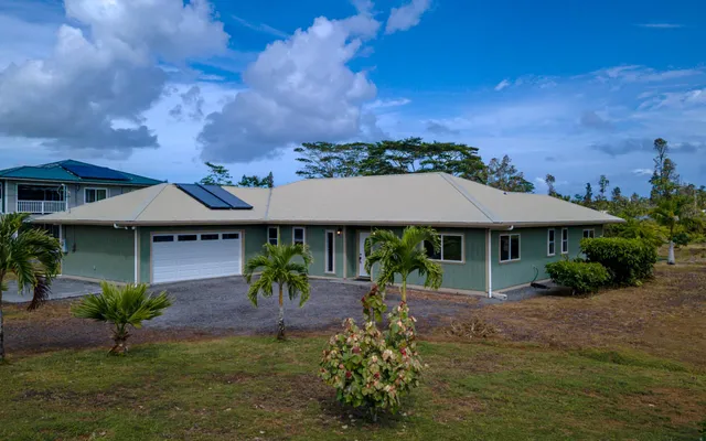 an aerial view of a house with a yard and lake view