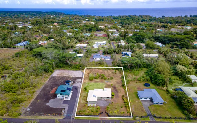 an aerial view of a house with a yard