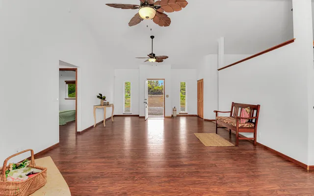 a view of a livingroom with hardwood floor and a ceiling fan