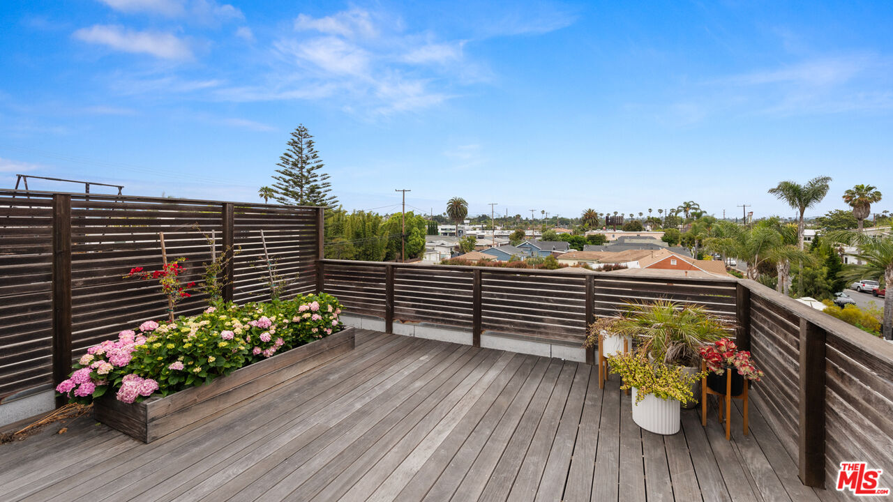 705 Sunset Avenue Venice, CA 90291 - Photo 19 of 32 a view of a balcony with wooden floor and flowers