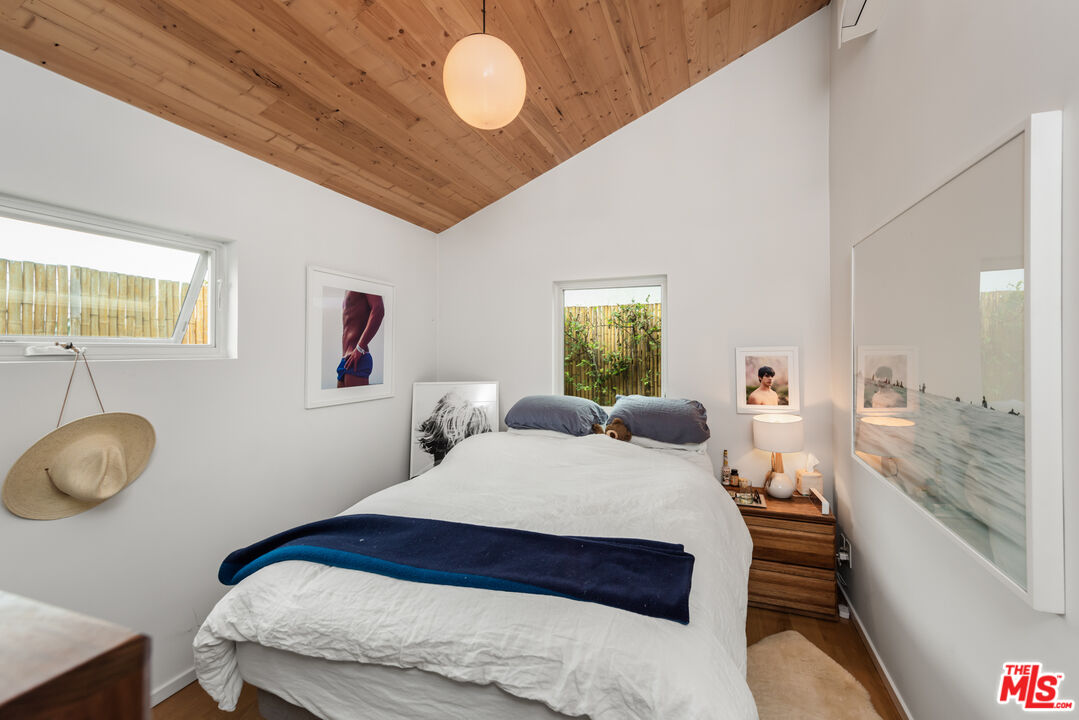 705 Sunset Avenue Venice, CA 90291 - Photo 27 of 32 a bedroom with a bed and a chandelier