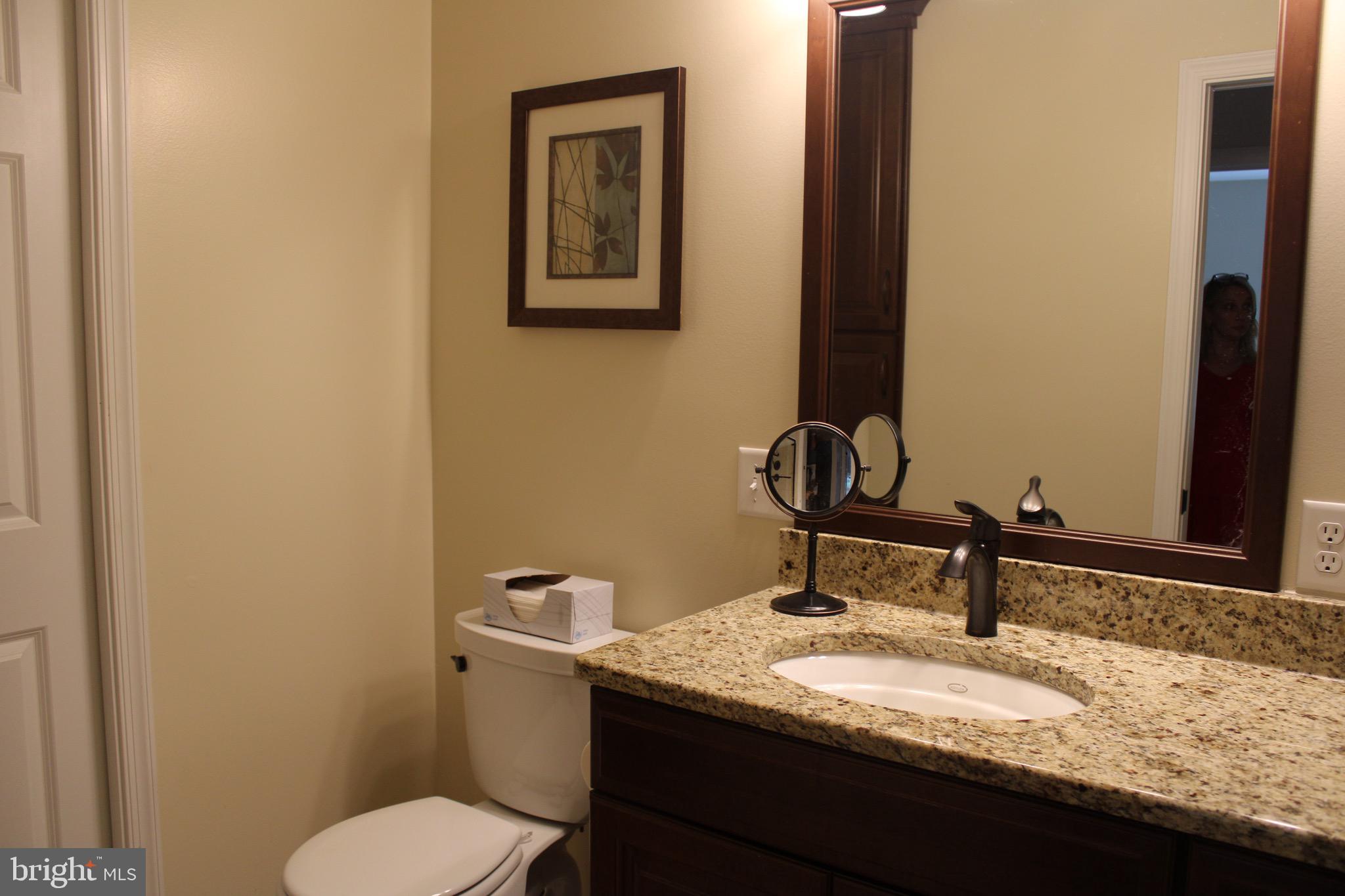 5331 Strasburg Road Kinzers, PA 17535 - Photo 14 of 31 a bathroom with a granite countertop toilet sink and mirror