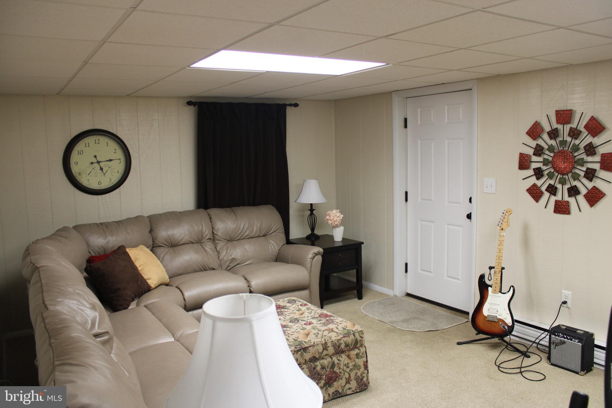5331 Strasburg Road Kinzers, PA 17535 - Photo 19 of 31 a living room with furniture a clock and a window