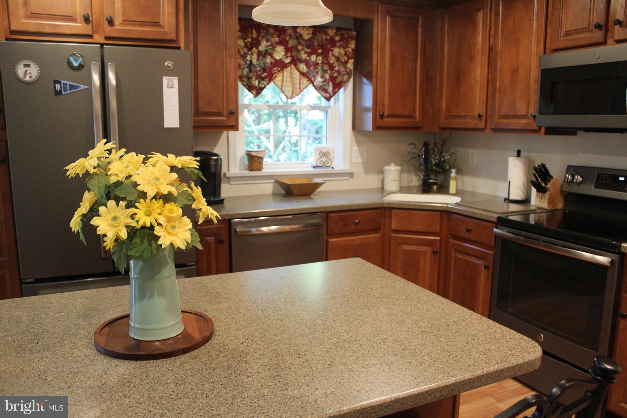5331 Strasburg Road Kinzers, PA 17535 - Photo 9 of 31 a kitchen with stainless steel appliances granite countertop a stove a sink dishwasher with a dining table and chair