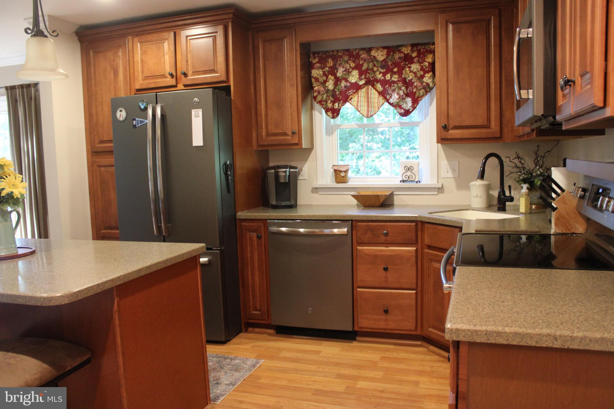 5331 Strasburg Road Kinzers, PA 17535 - Photo 10 of 31 a kitchen with stainless steel appliances granite countertop a sink stove and refrigerator