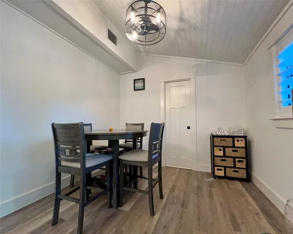 a bedroom with a bed a dresser and a window