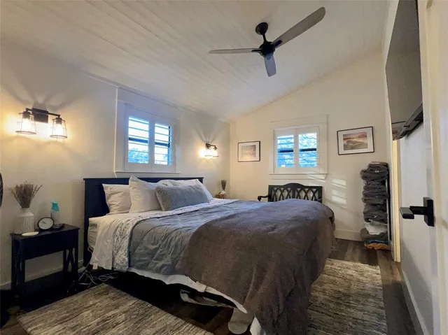 a bathroom with a toilet sink vanity and mirror
