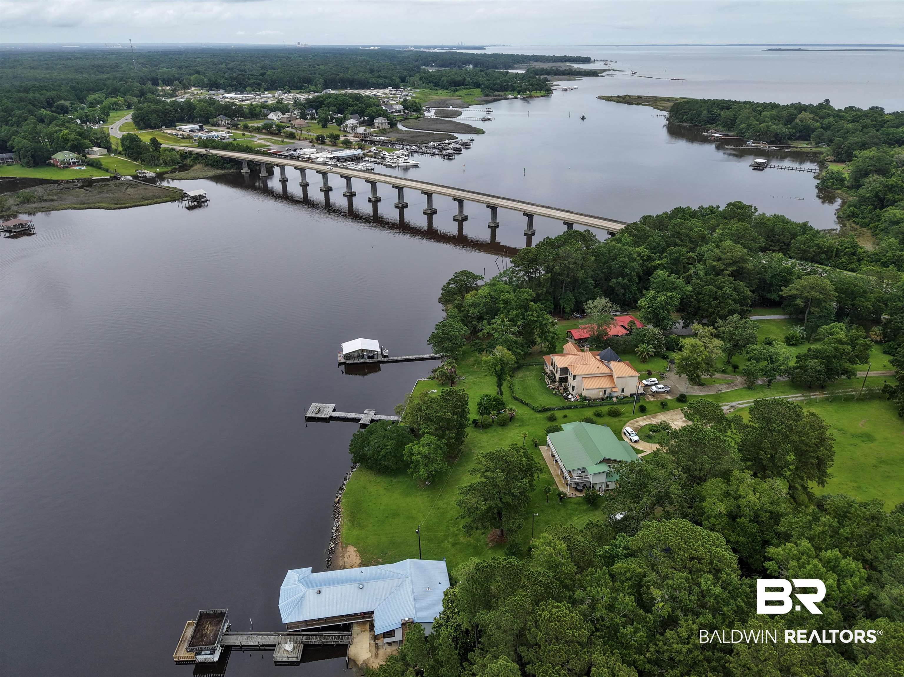 12171 Marguerite Drive Coden, AL 36523 - Photo 33 of 44 Waterfront property featuring a private boat dock with covered slip, direct water access, and mature trees
