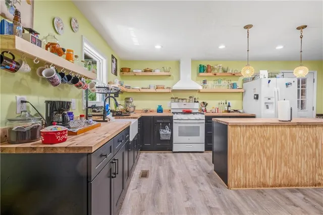 a kitchen with a sink stove and cabinets