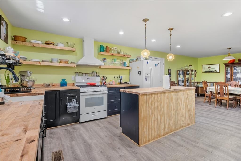 565 Raiford Road Cedartown, GA 30125 - Photo 13 of 37 a kitchen with stainless steel appliances granite countertop a stove a sink a oven and a dining table with wooden floor