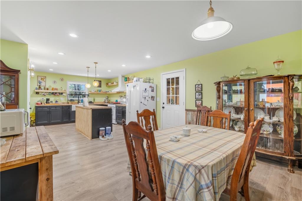 565 Raiford Road Cedartown, GA 30125 - Photo 15 of 37 a dining room with stainless steel appliances kitchen island granite countertop a table chairs and a refrigerator