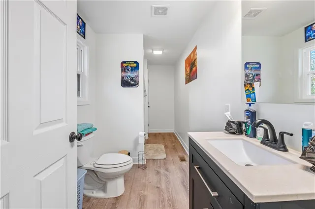 a bathroom with a sink a toilet and shower curtain