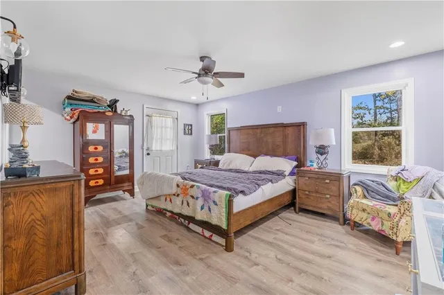 a bedroom with a bed couch and a window