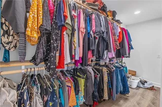 a view of walk in closet with clothes