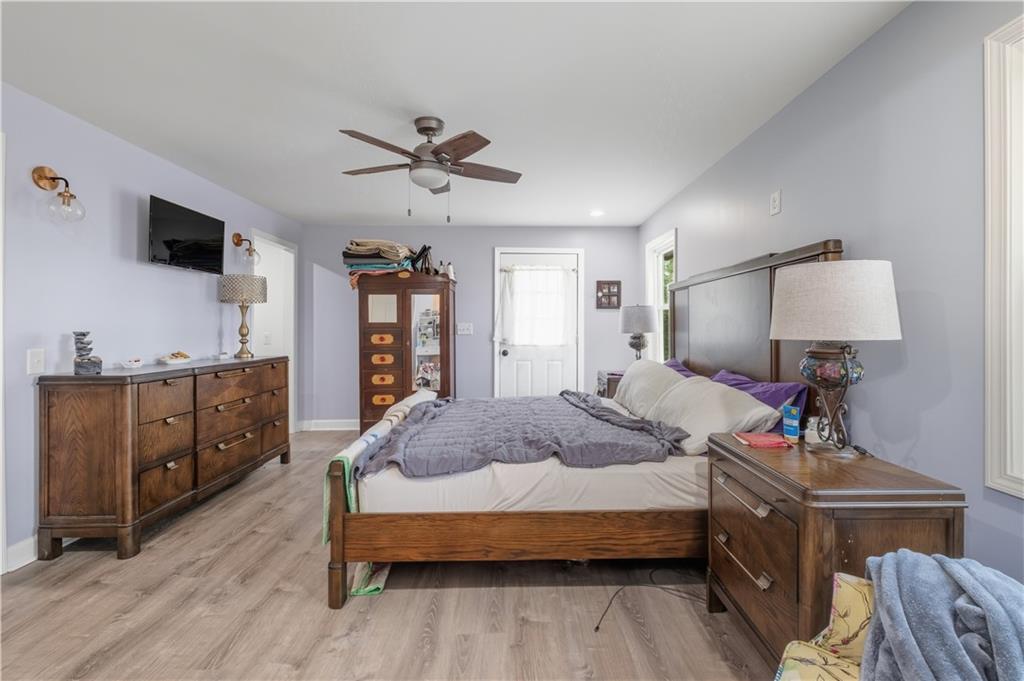 565 Raiford Road Cedartown, GA 30125 - Photo 26 of 37 a spacious bedroom with a bed and a flat tv screen on dresser