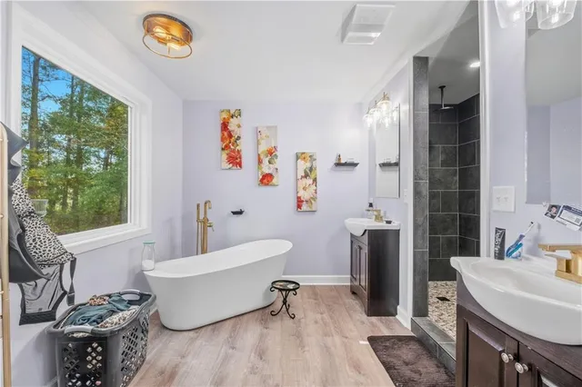 a bathroom with a sink a bathtub and a shower