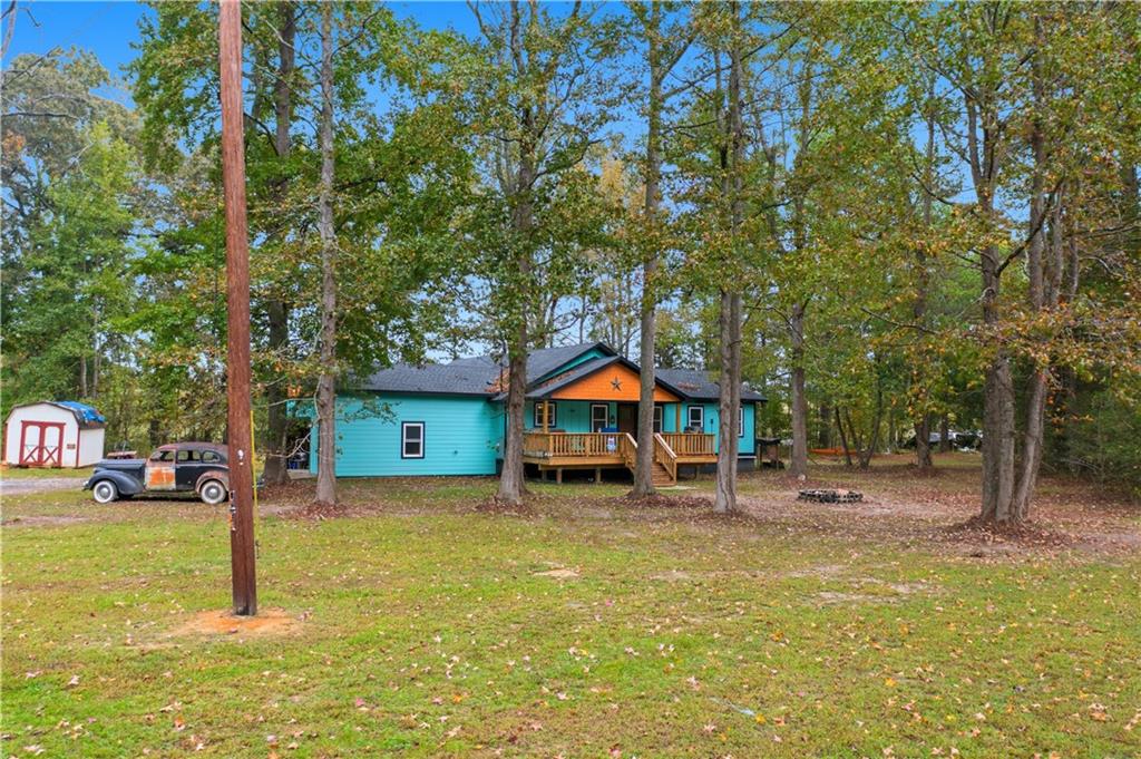 565 Raiford Road Cedartown, GA 30125 - Photo 3 of 37 a front view of a house with a yard garage and outdoor seating