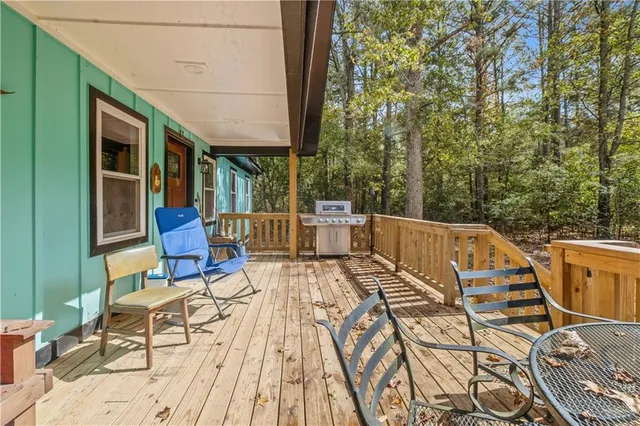 a view of a patio with table and chairs and wooden floor