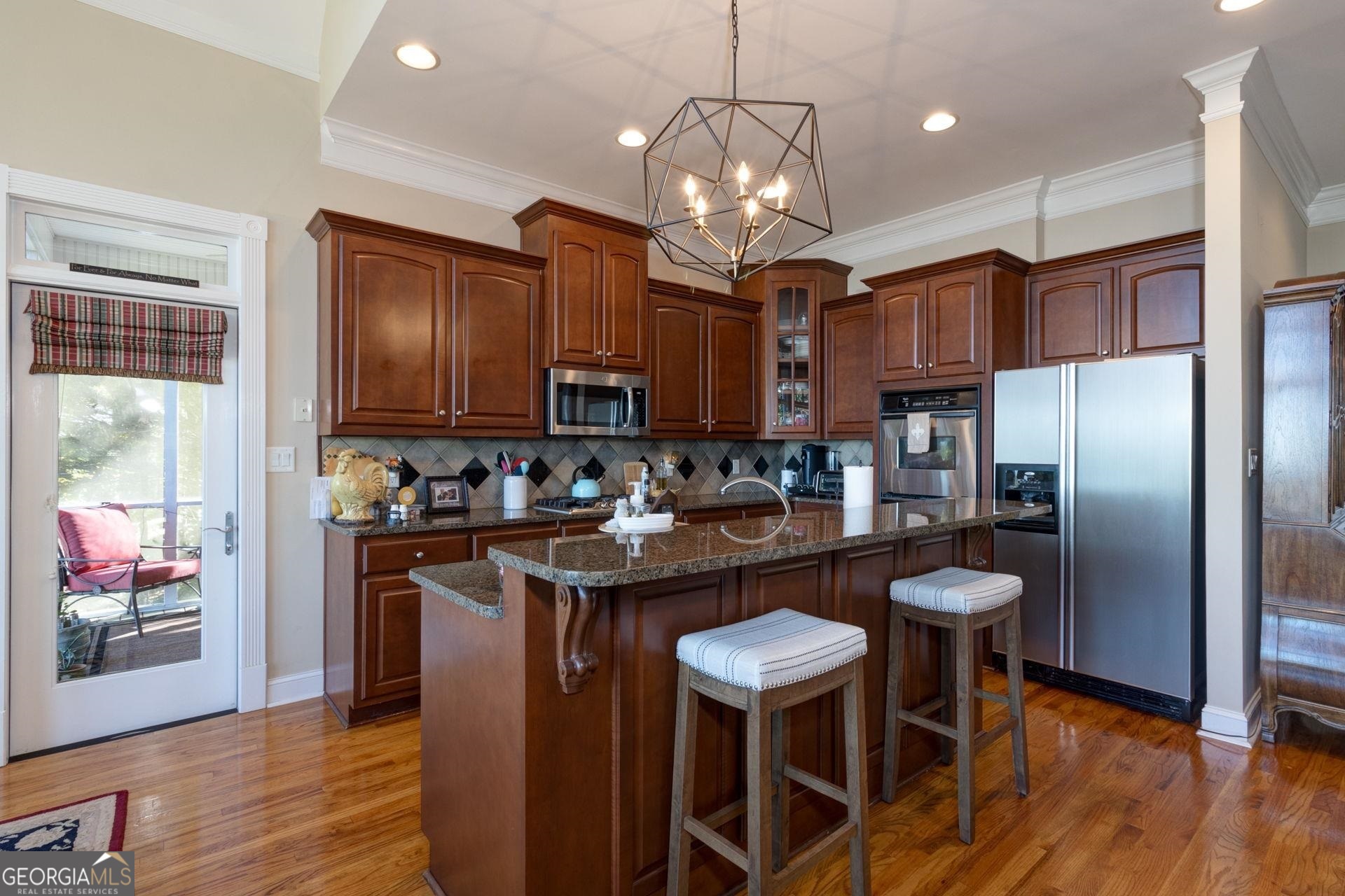 551 Mountain Ridge Drive Manchester, GA 31816 - Photo 15 of 72 Granite counters and custom cabinets give this kitchen an elevated feel. New light fixture over island/breakfast bar was recently installed.