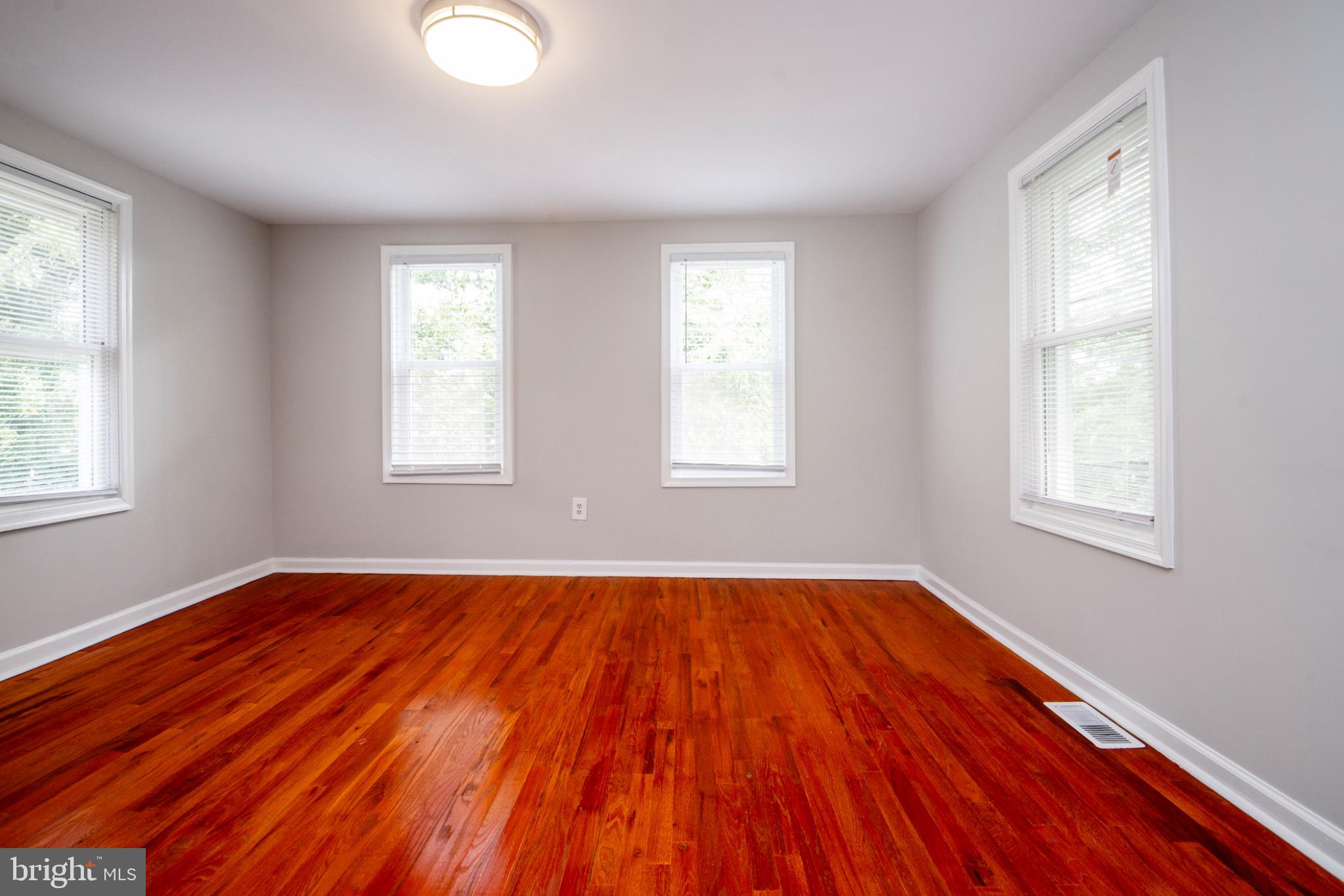 3708 7th Street Baltimore, MD 21225 - Photo 7 of 8 Bright and airy room with hardwood floors.